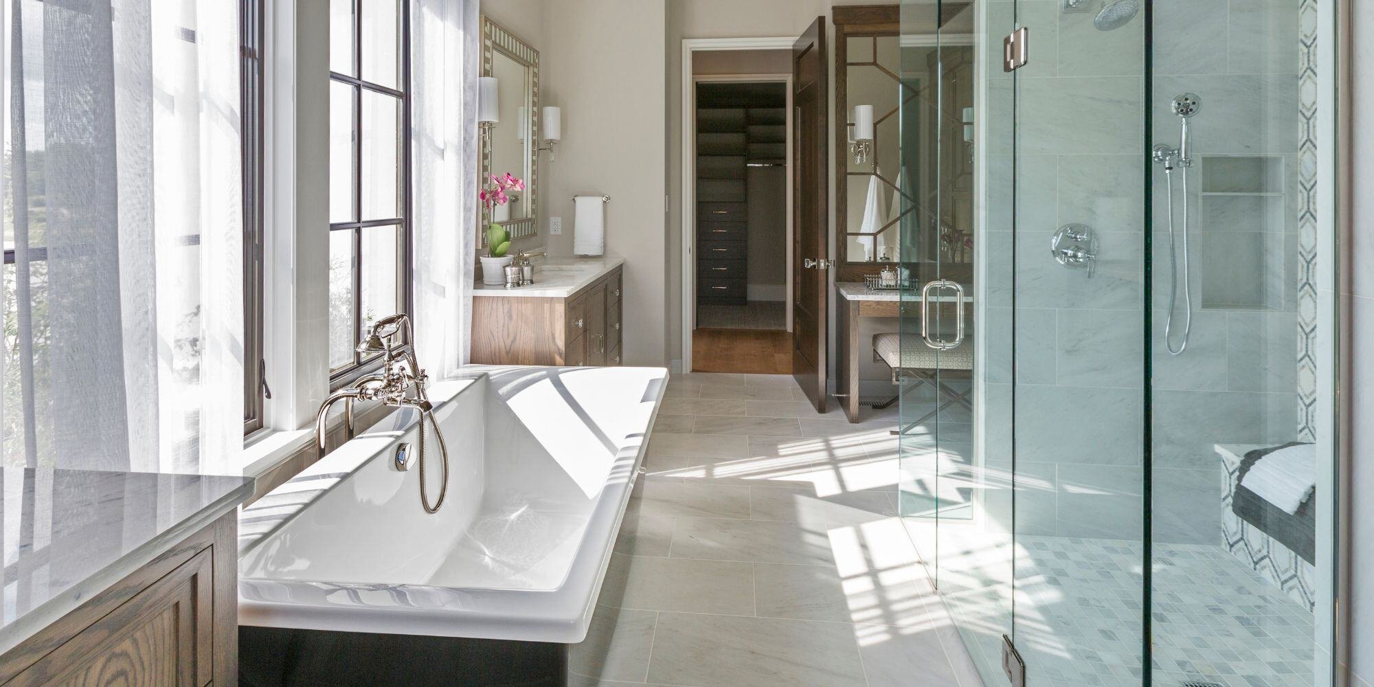 master bathroom remodel with large bath tub, natural light, and glass walk in shower