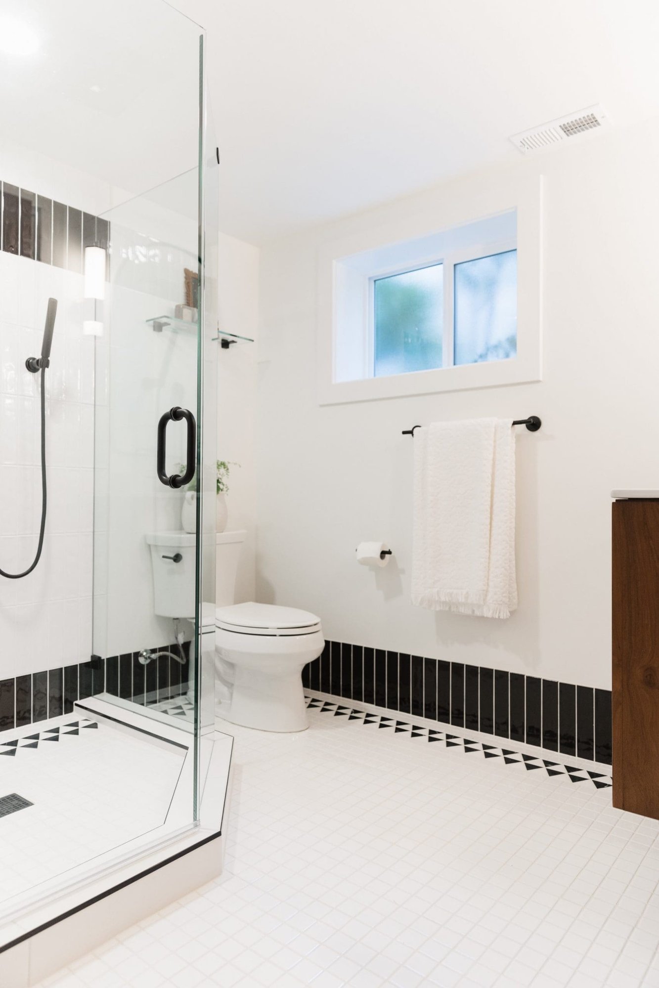 bathroom in basement remodel with glass frameless shower and modern farmhouse aesthetic