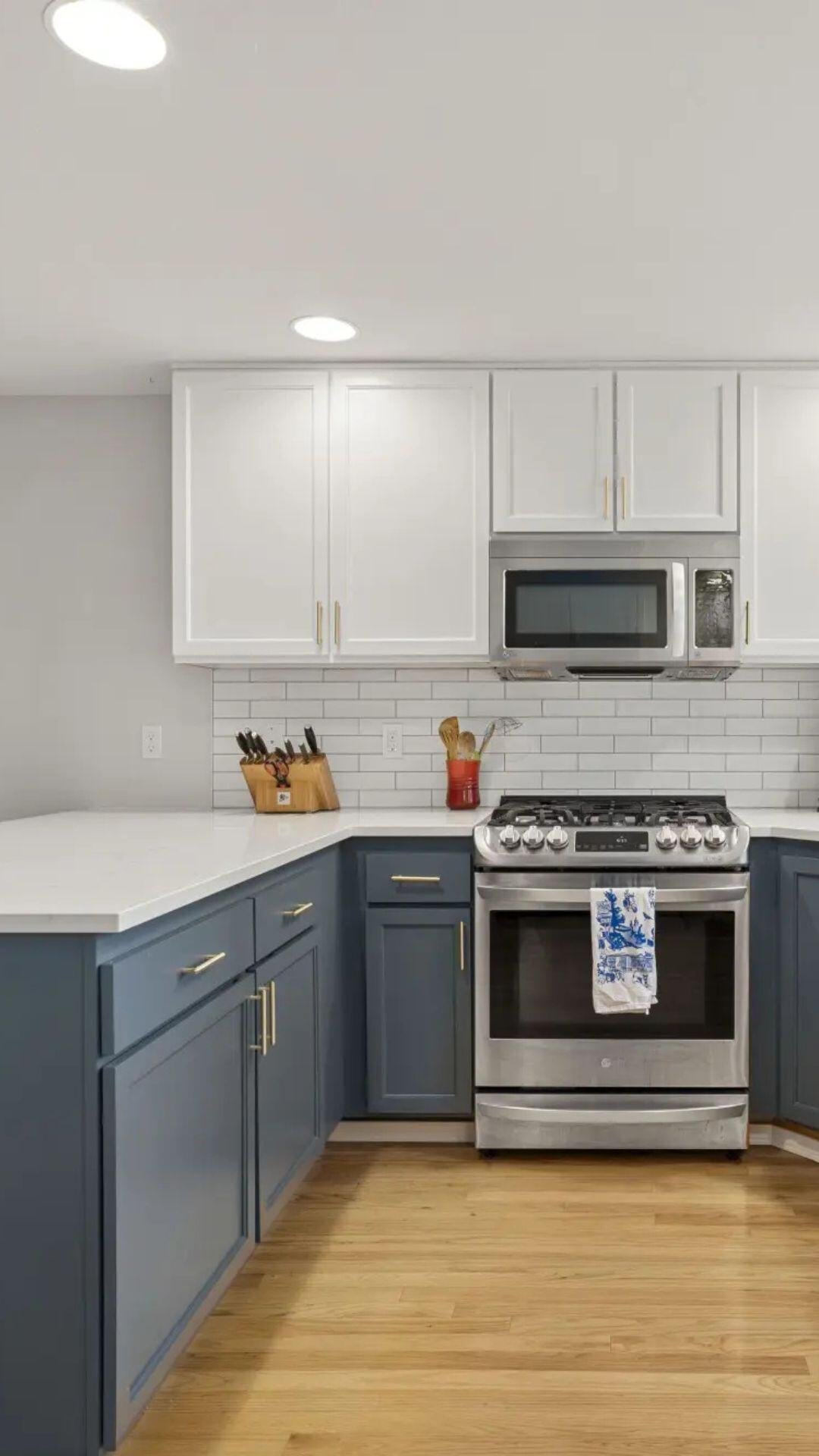 kitchen remodel in interlake with blue lower cabinets and white upper cabinets and white countertops