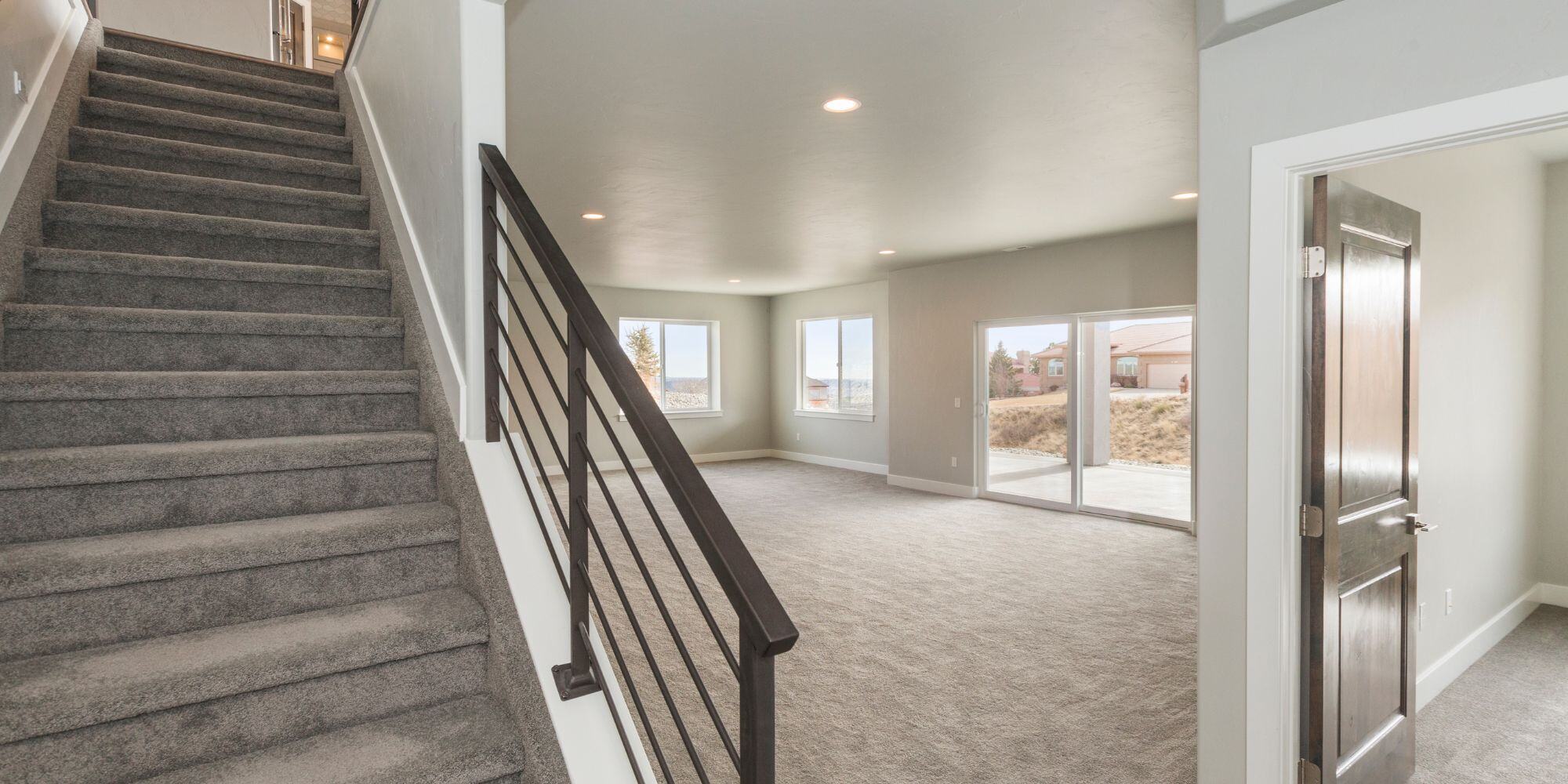 finished basement remodel in seattle with black railing and carpet