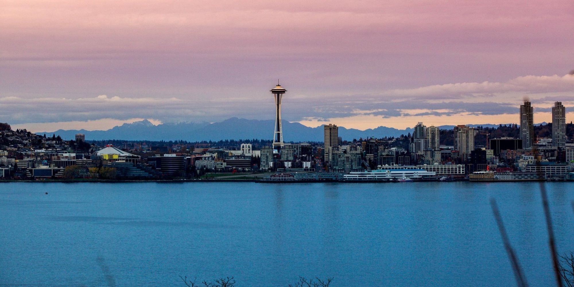 Seattle skyline over a body of water at sunset